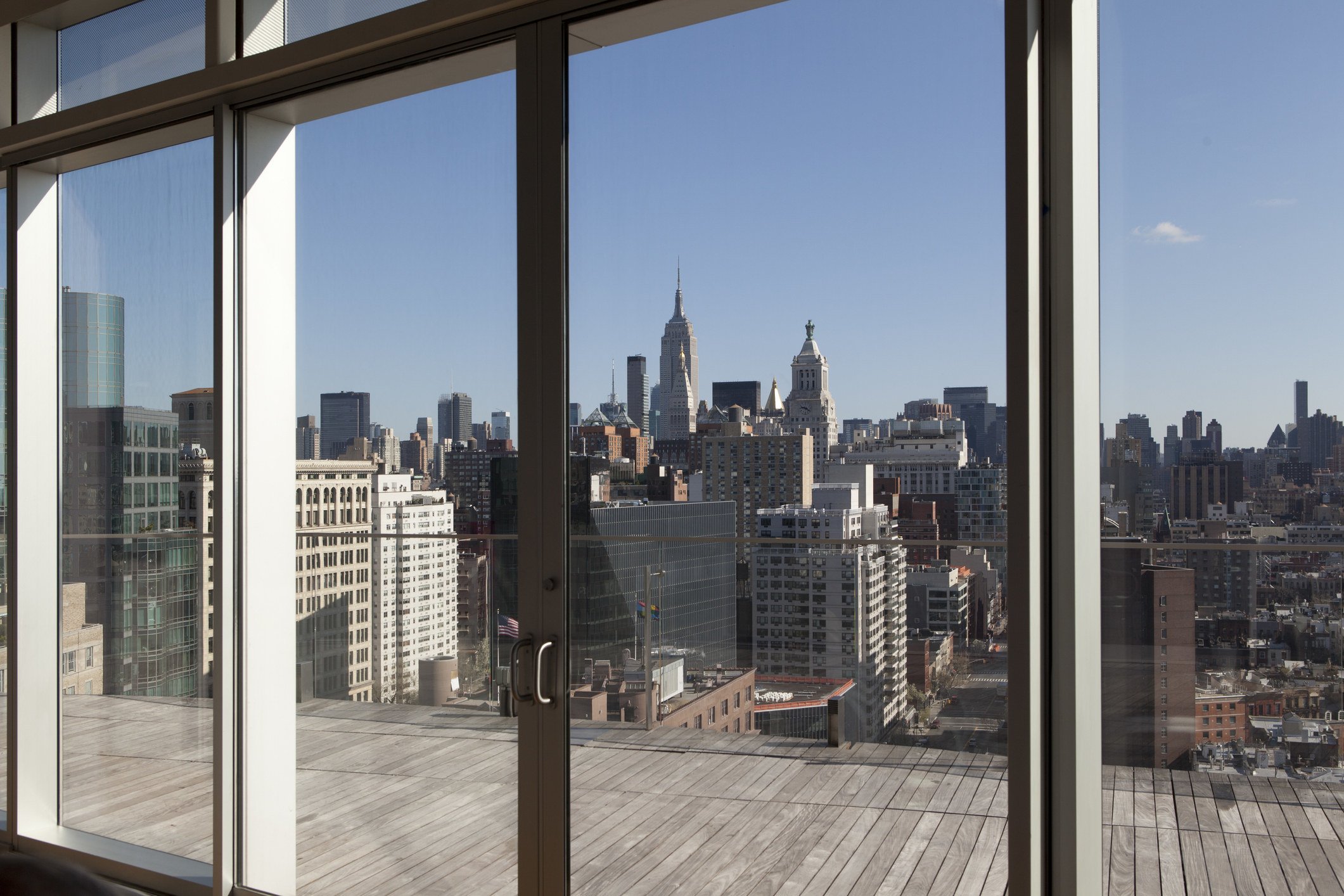 A view of the New York skyline through the floor-to-ceiling windows of an apartment
