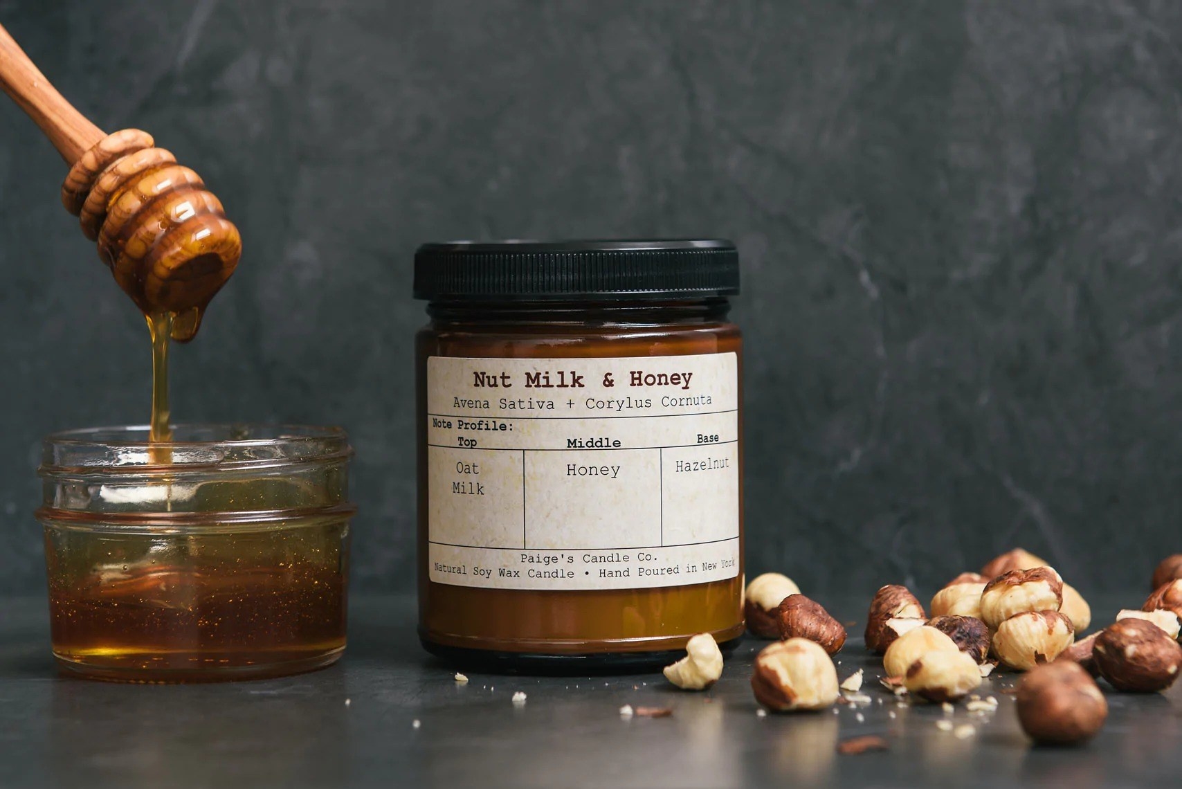 the nut milk and honey candle with the featured ingredients sat beside it