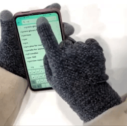 a gif of someone using a phone with the gloves on