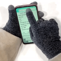 a gif of someone using a phone with the gloves on