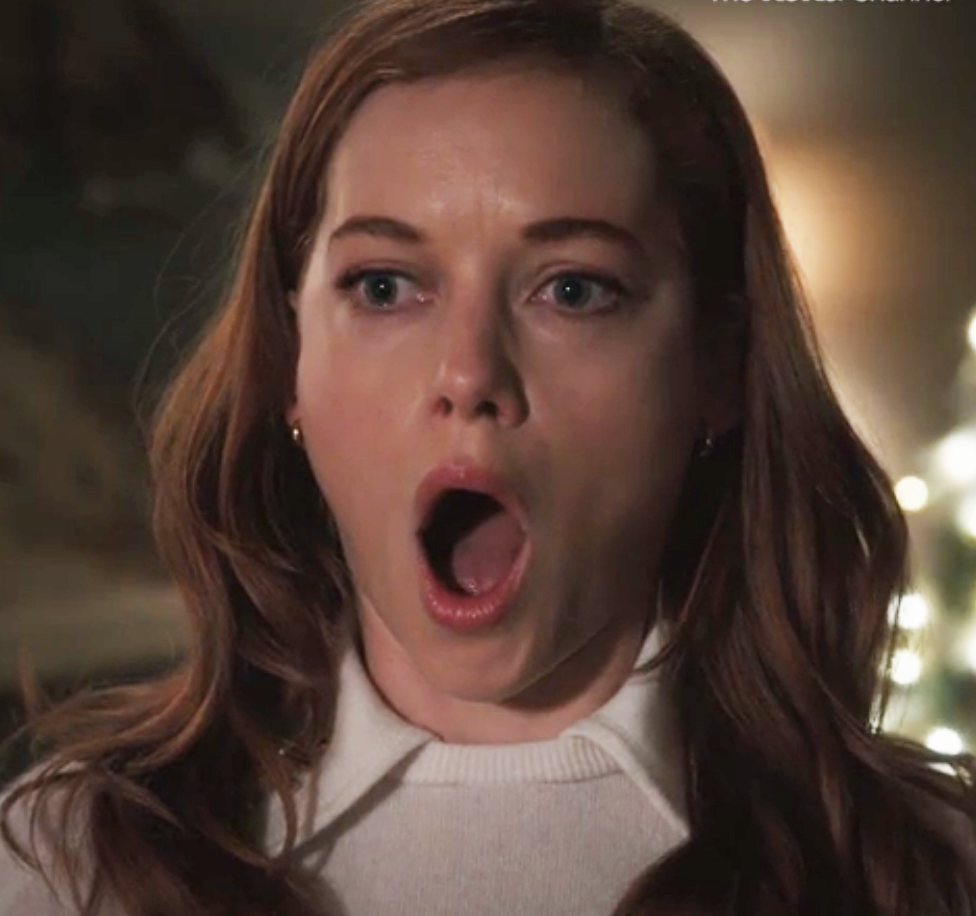 a woman opening her mouth in surprise