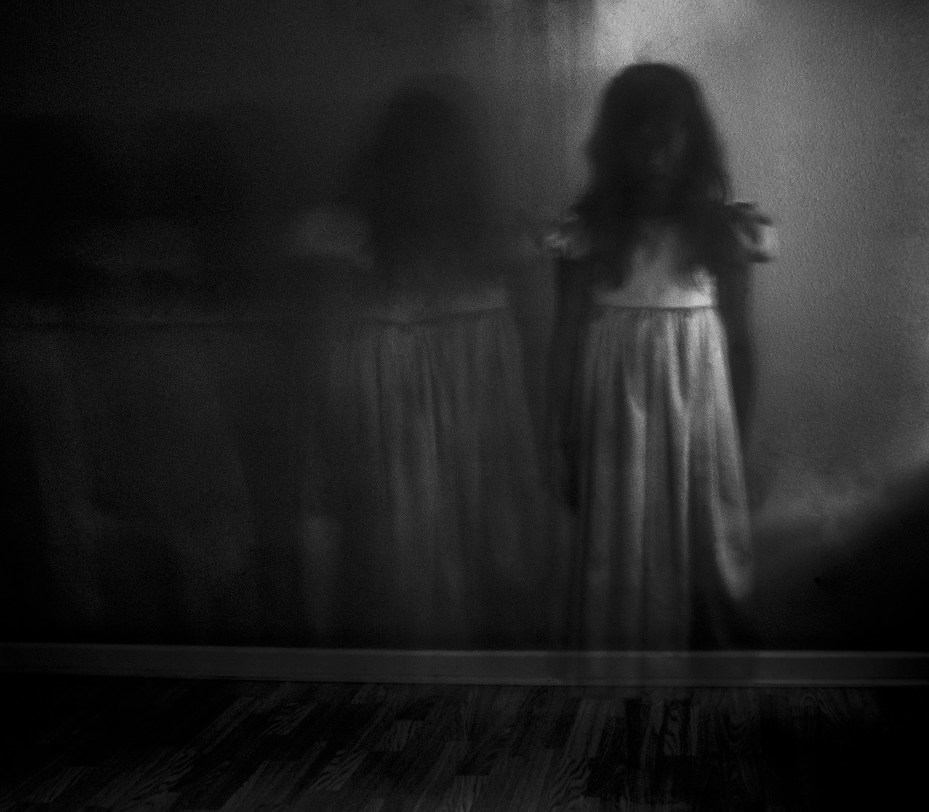 A ghostly little girl in a white dress