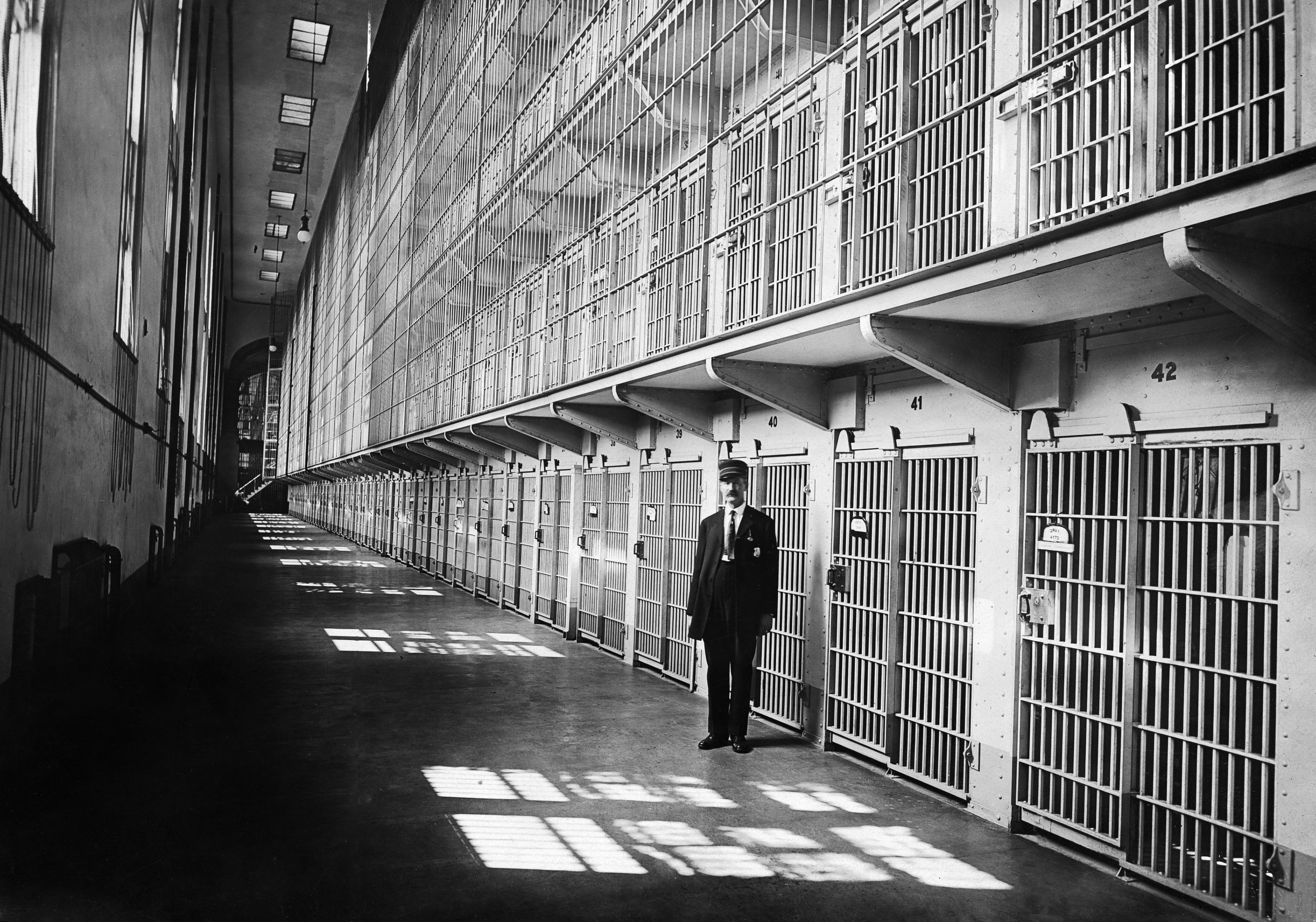 Man stands outside cells