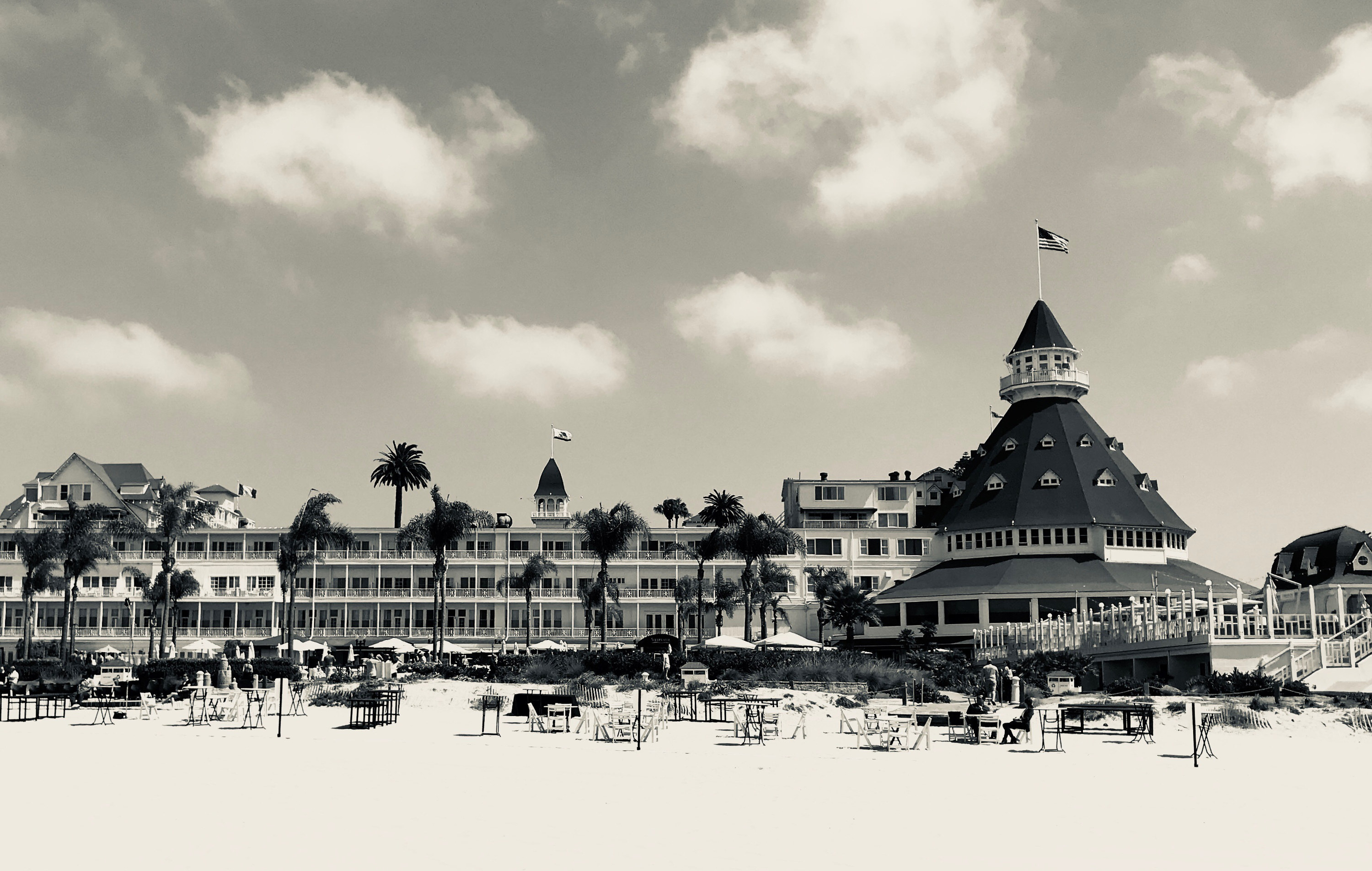 Black and white photo of a beachfront hotel