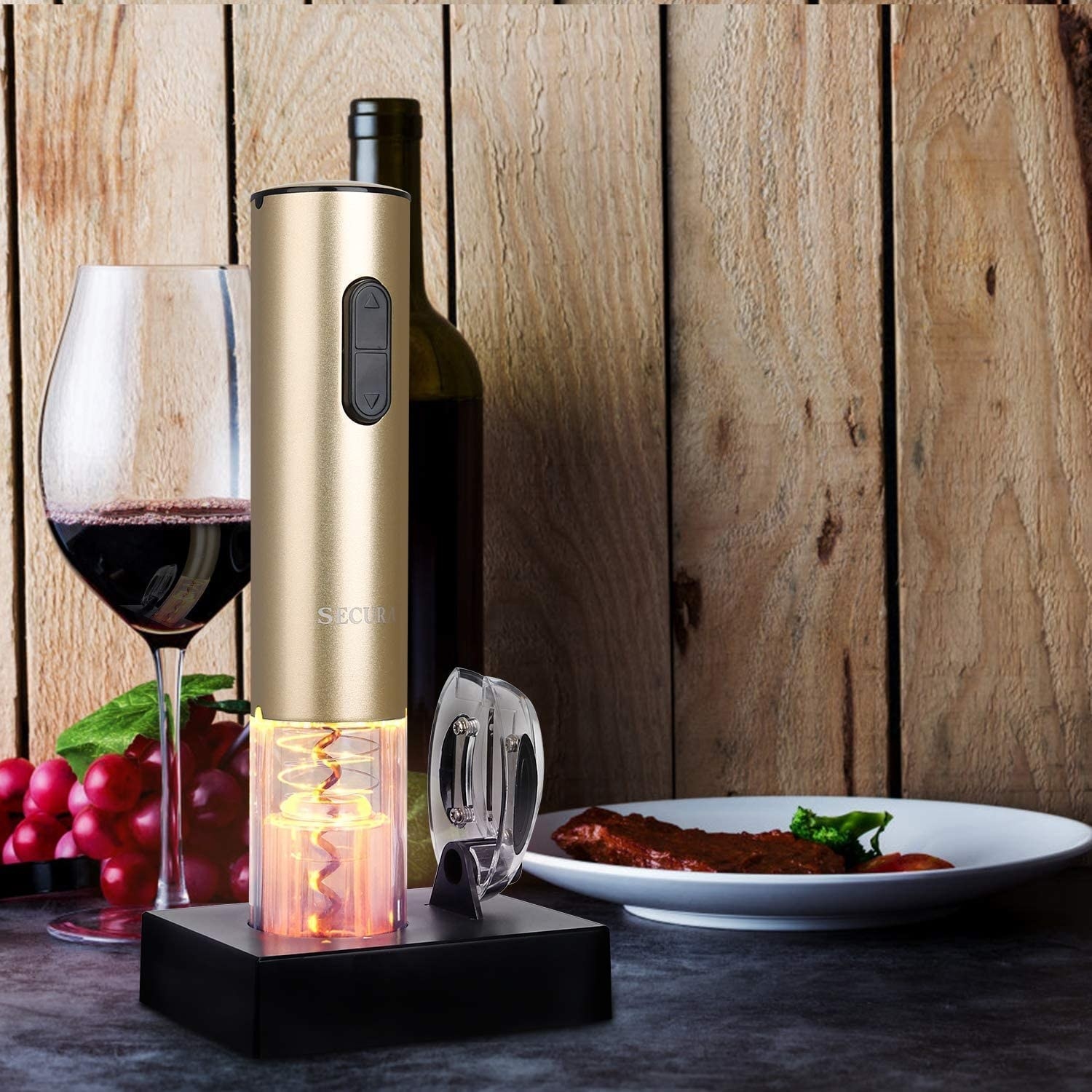 the wine bottle opener beside a glass and bottle of wine and a plate of food