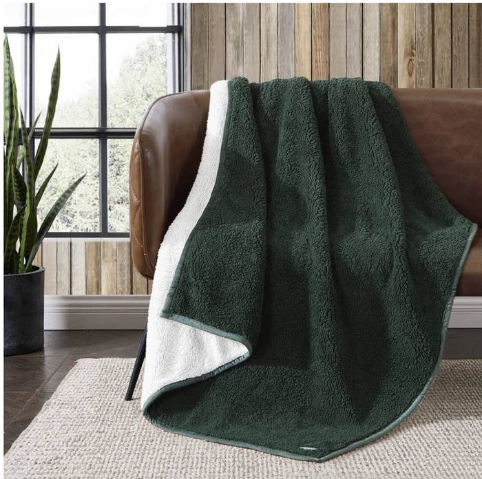 The green and white throw draped over a sofa