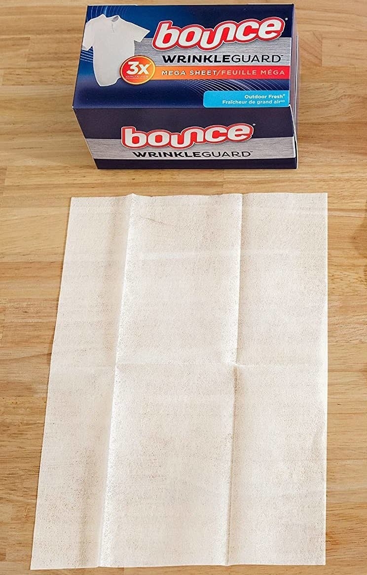 a large bounce sheet next to its packaging on a wood surface