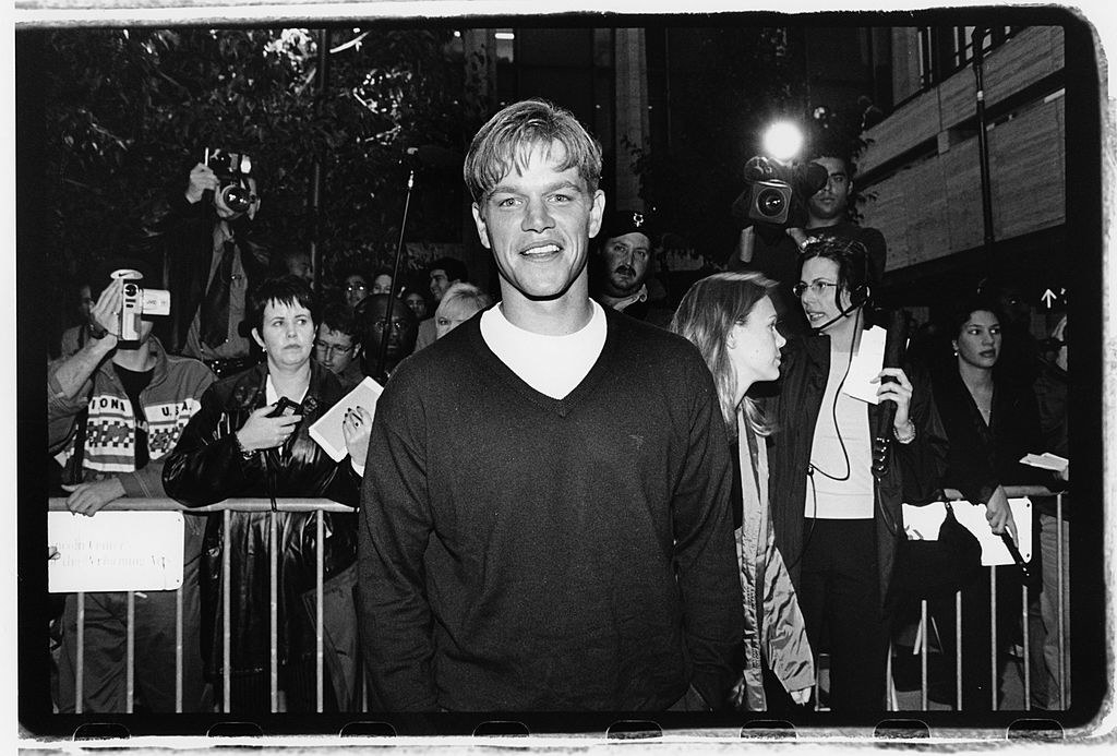 Matt Damon smiling outside in front of photographers