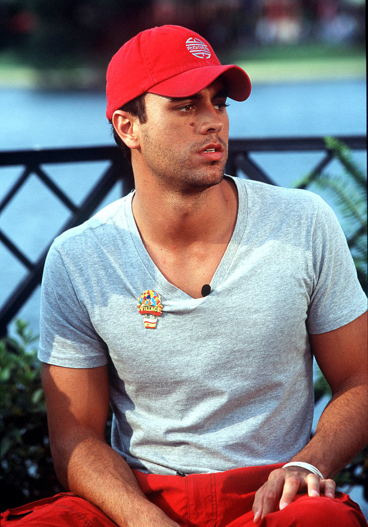 Enrique Iglesias sitting outside and looking at something