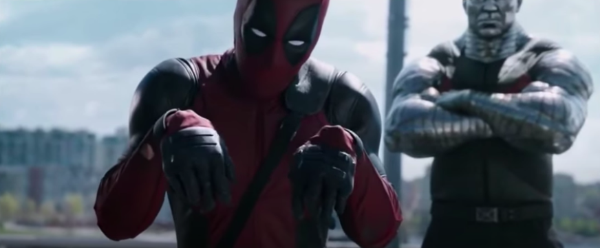 Deadpool stands with both of his wrists broken