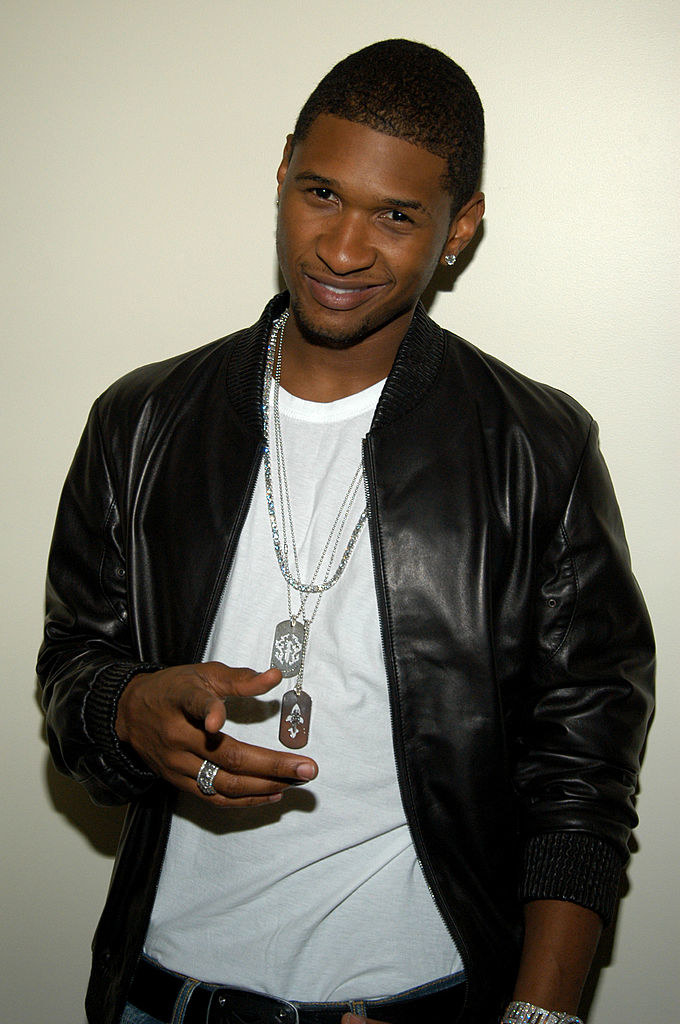 Usher pointing at the camera and smiling