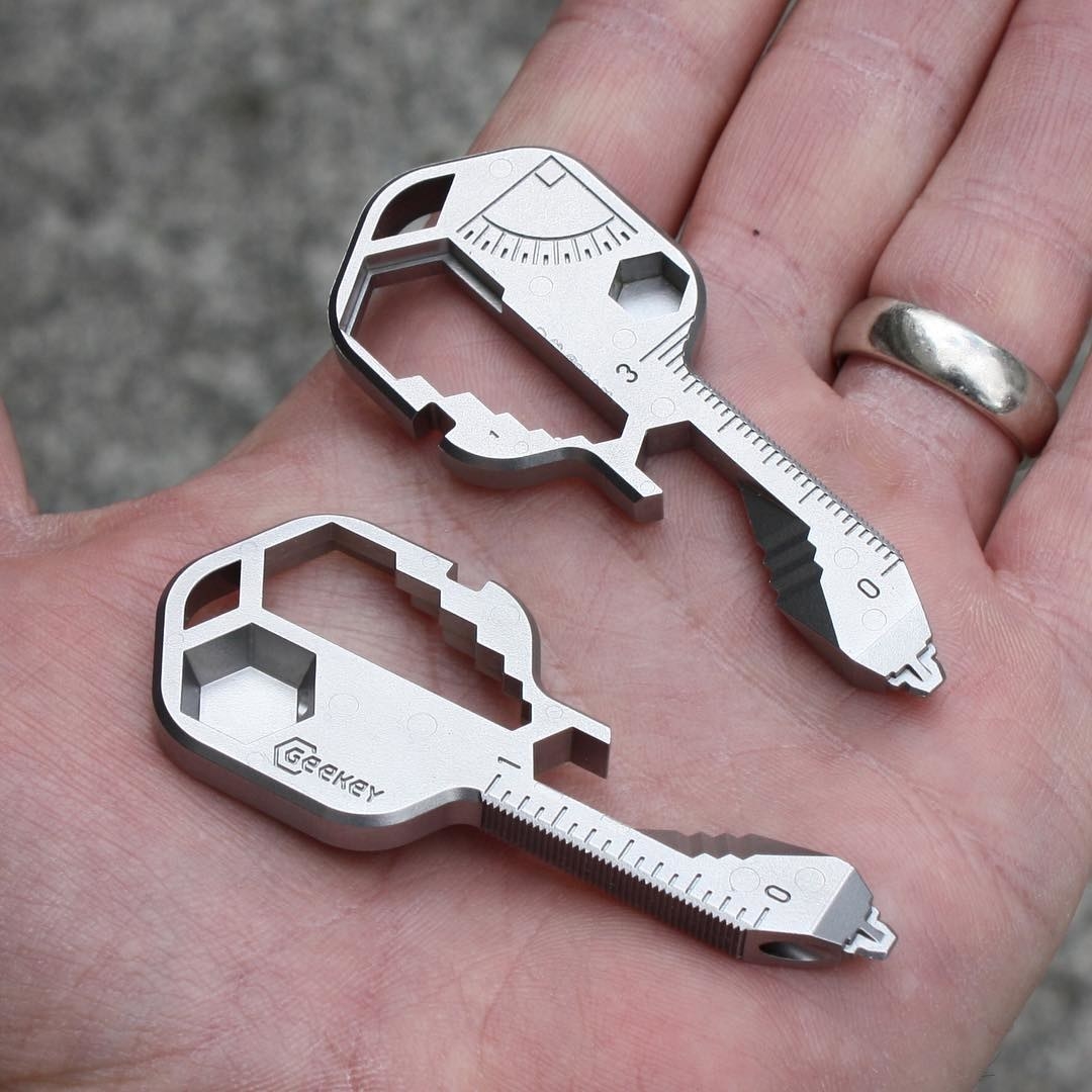 a pair of key shaped multitools in a person&#x27;s palm