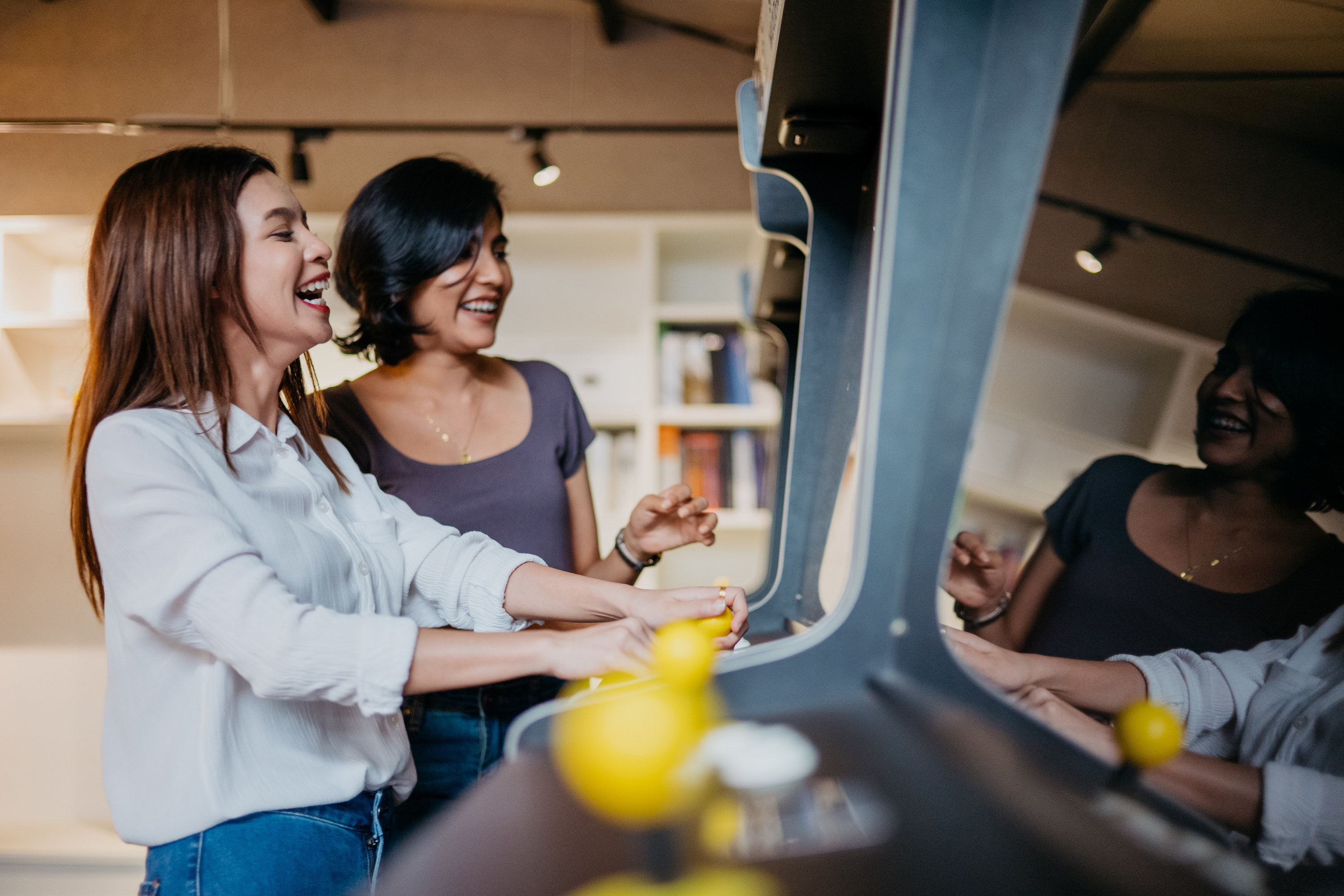 two people playing an arcade game