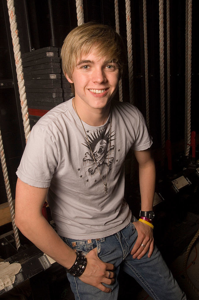 Jesse McCartney smiling with his thumbs in his pockets