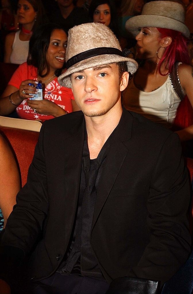 Justin Timberlake sitting down and wearing a fedora hat
