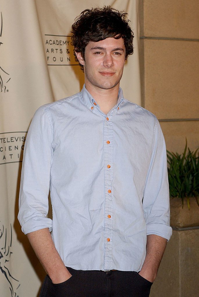 Adam Brody standing with his hands in his pockets
