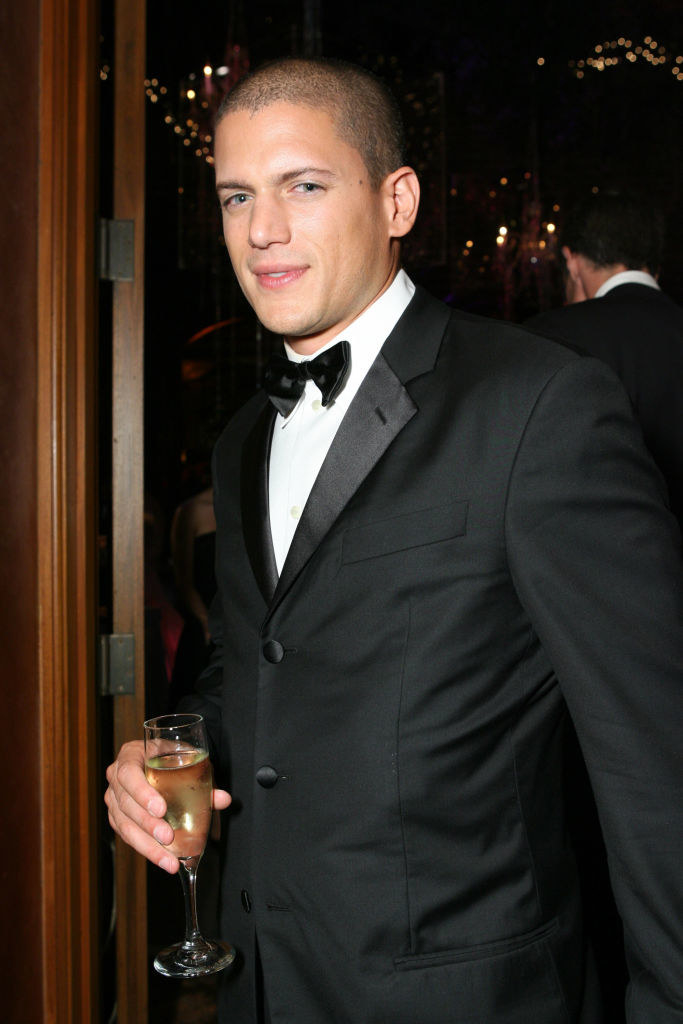 Wentworth Miller holding a glass of champagne