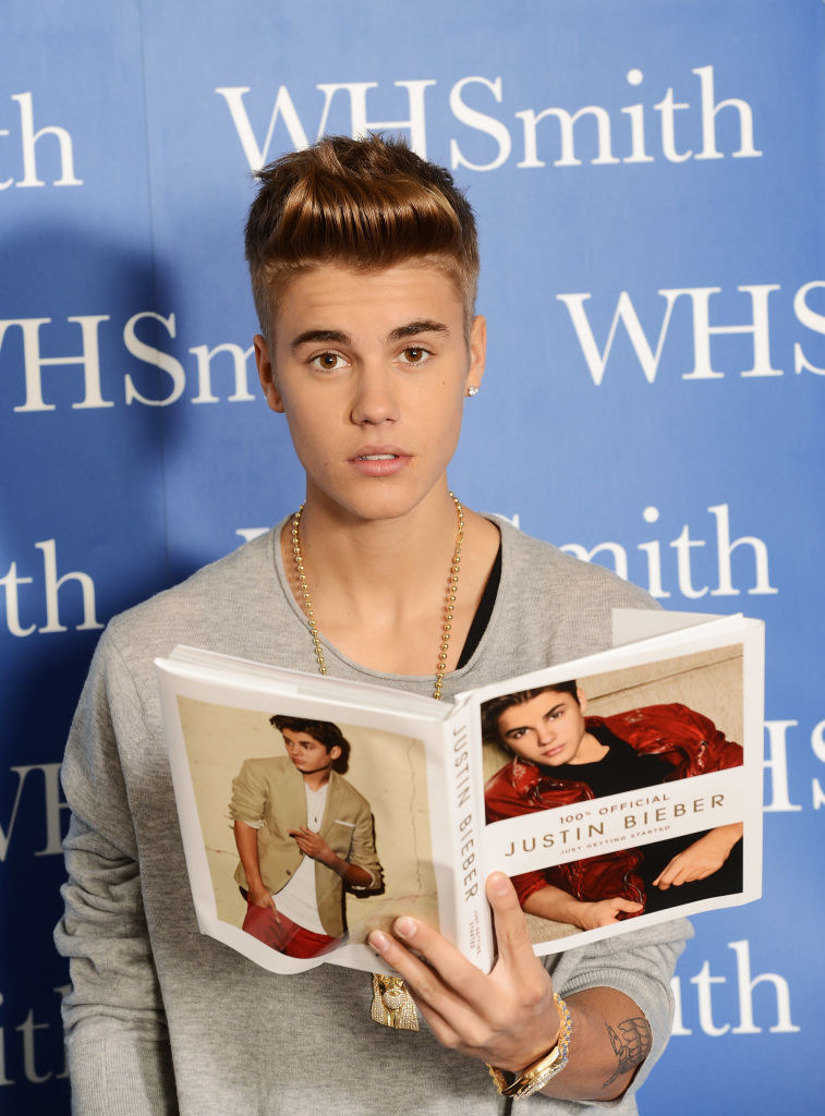 Justin Bieber reading a book about himself