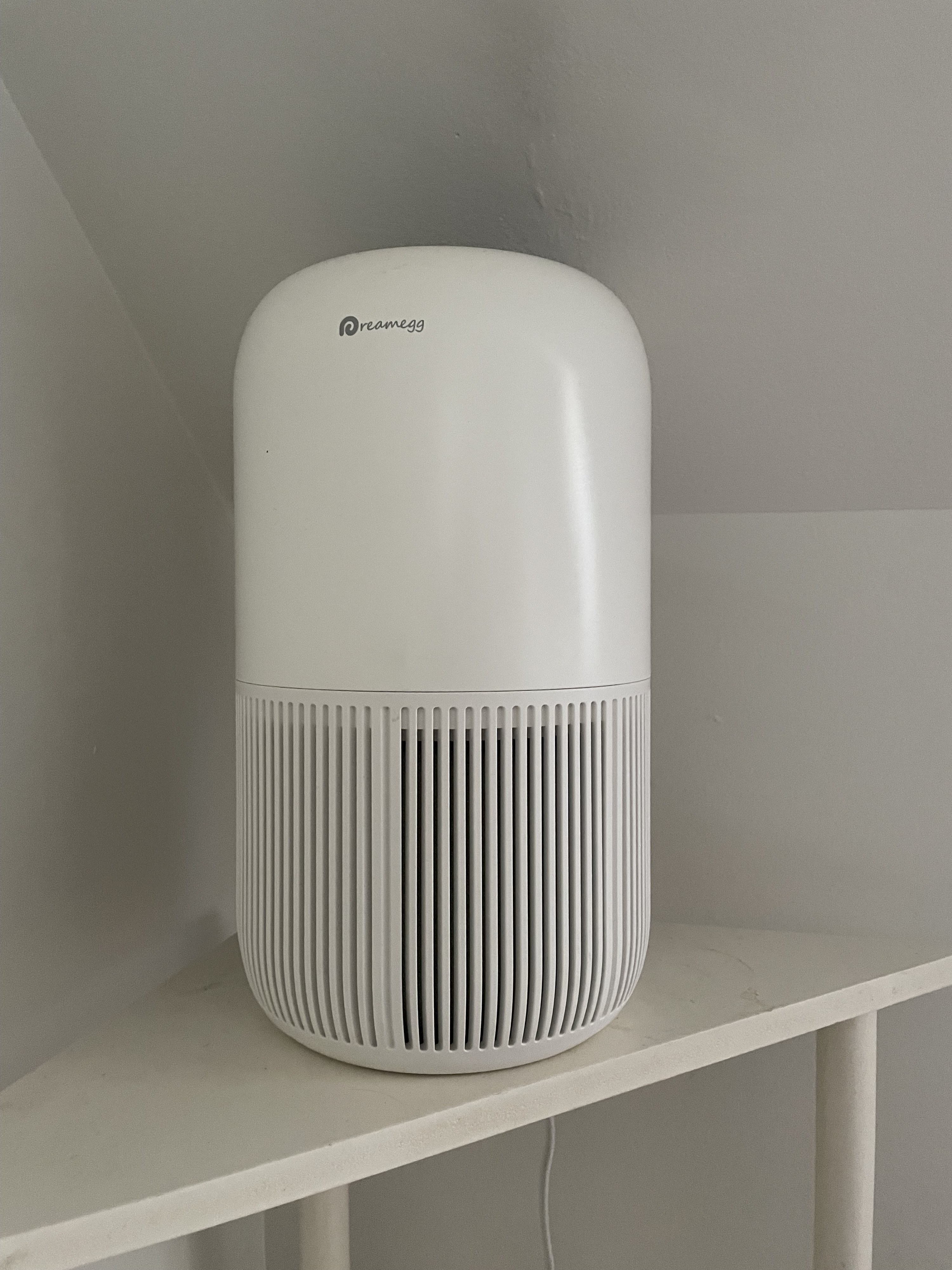 the air purifier on a bedside table