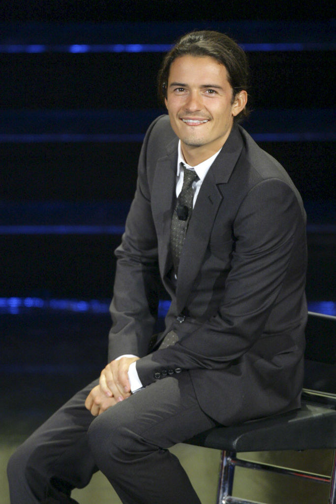 Orlando Bloom sitting and smiling
