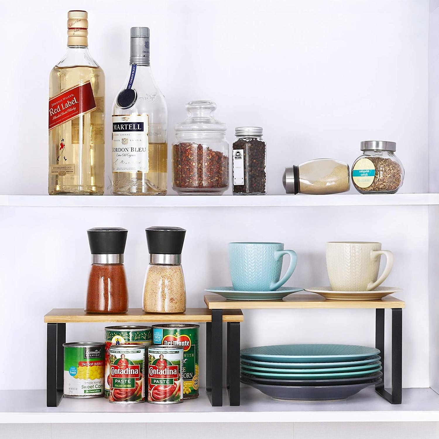 two mini shelves on a larger shelf organizing plates and food