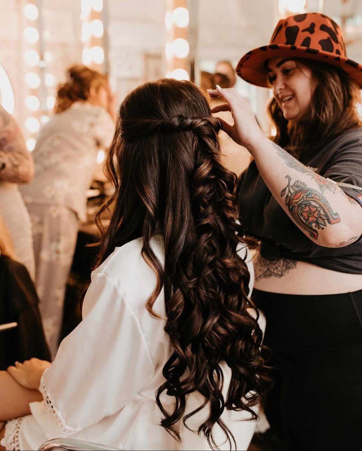 A hairstylist working with a model