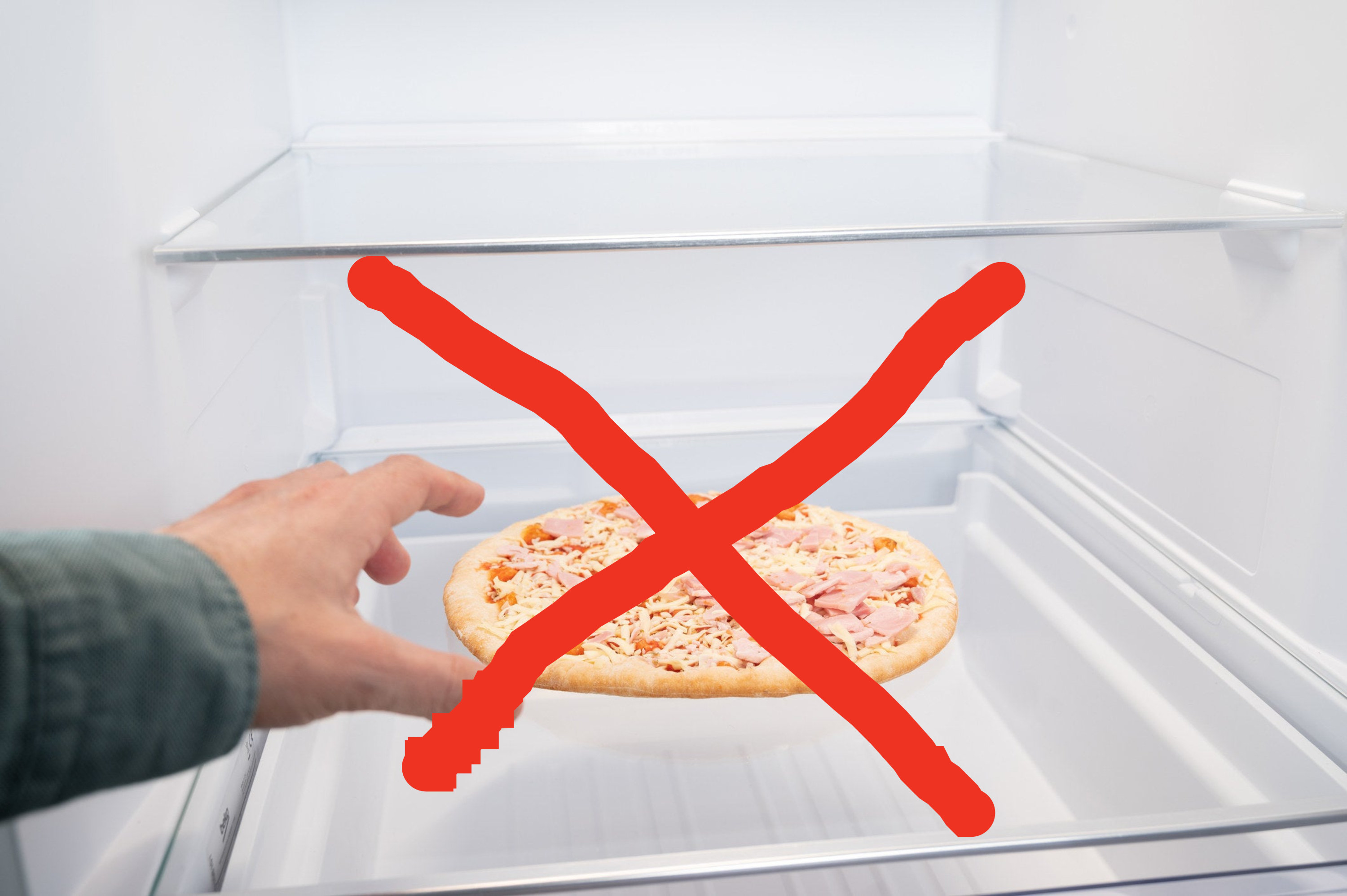 person reaching into a freezer for a frozen pizza