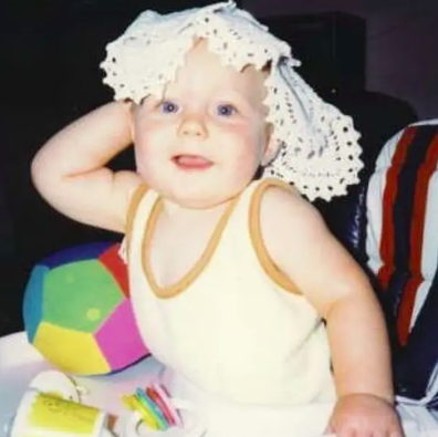 a baby with a doily on its head
