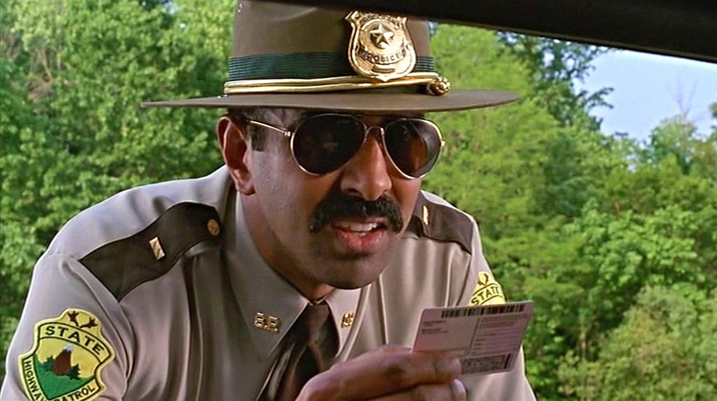 A policeman looking at a license