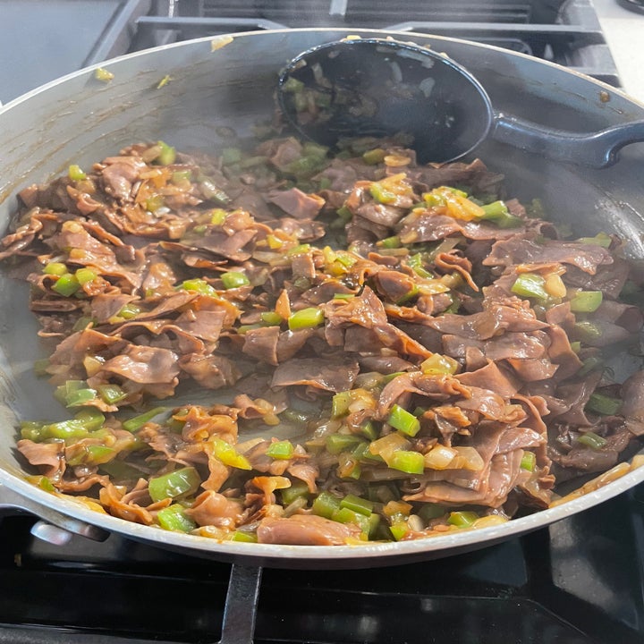 meat and vegetables cooking in a pan