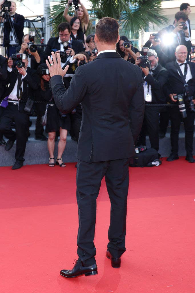 someone being photograhed on the red carpet by many photographers