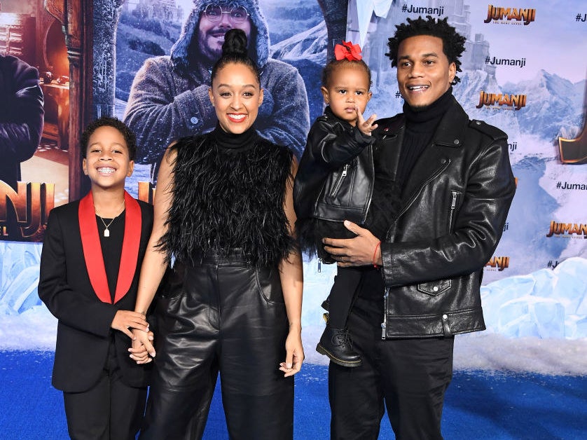 The couple and their two children smile on the red carpet