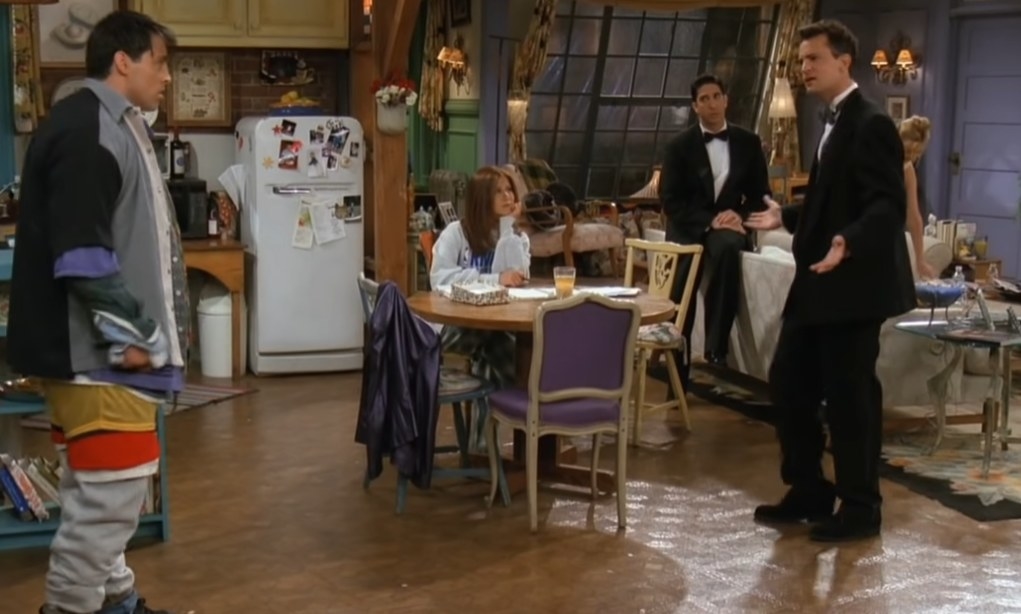 The cast of Friends all together while Joey played by Matt Leblanc is wearing layer upon layers of clothes