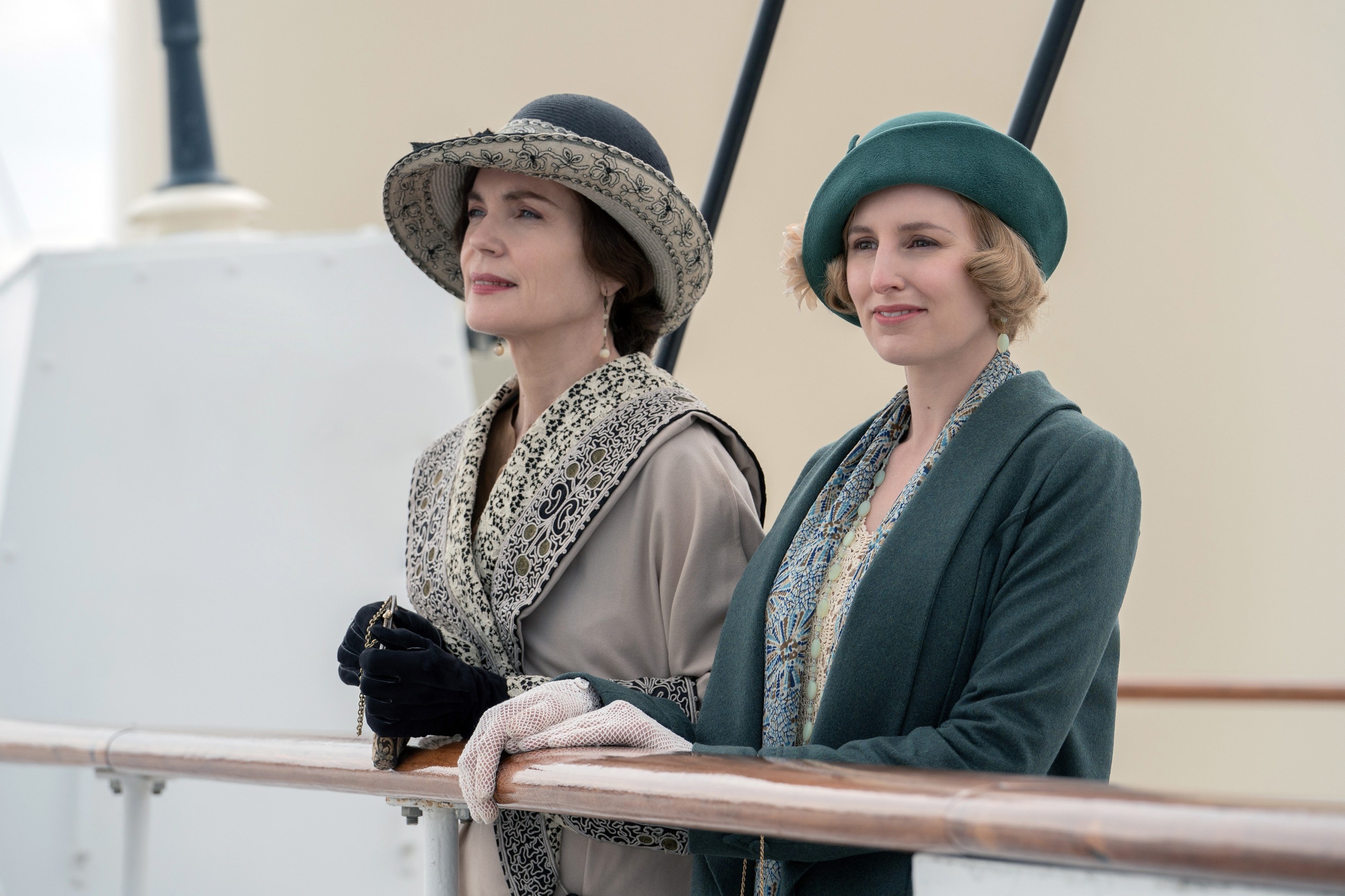 Elizabeth McGovern and Laura Carmichael stand on a ship
