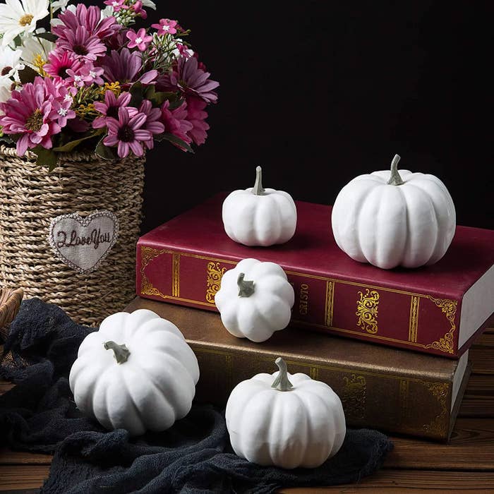 White pumpkins displayed in books