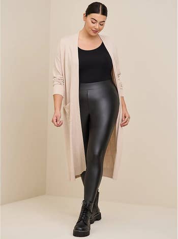 model wearing the black leggings with a long cardigan