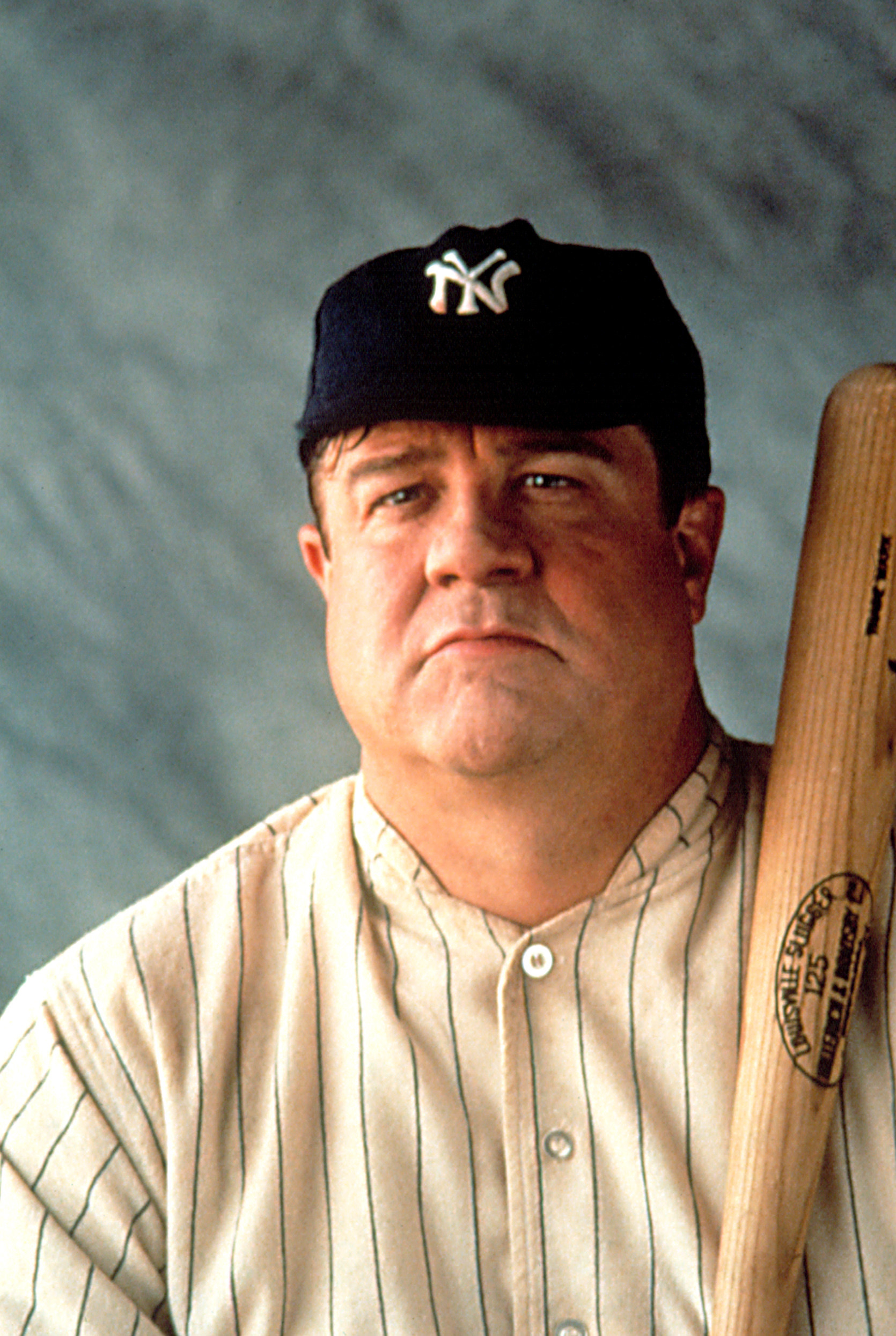 Close-up of John in a baseball uniform and holding a bat