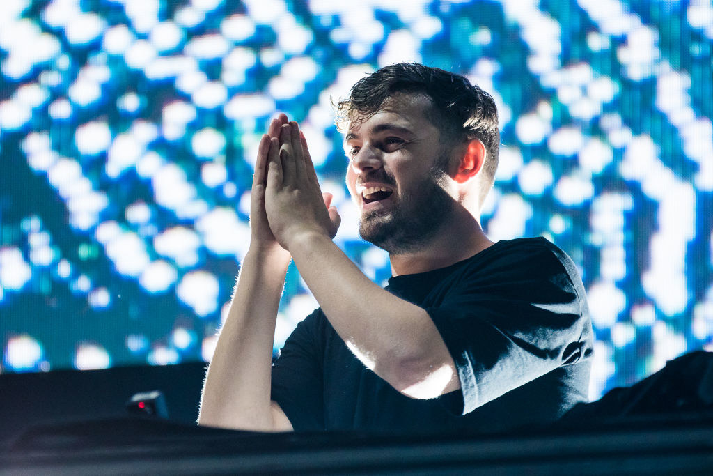 Martin Garrix smiling and putting his hands together