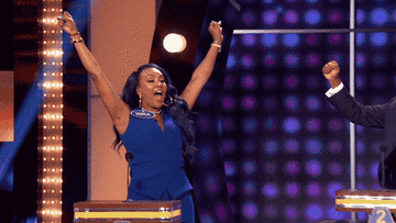 Vivica A. Fox raising her hands in triumph on the show