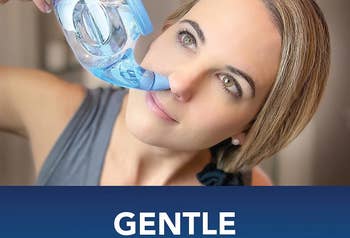 model using the blue neti pot, holding it up to their nose and tilting their head sideways
