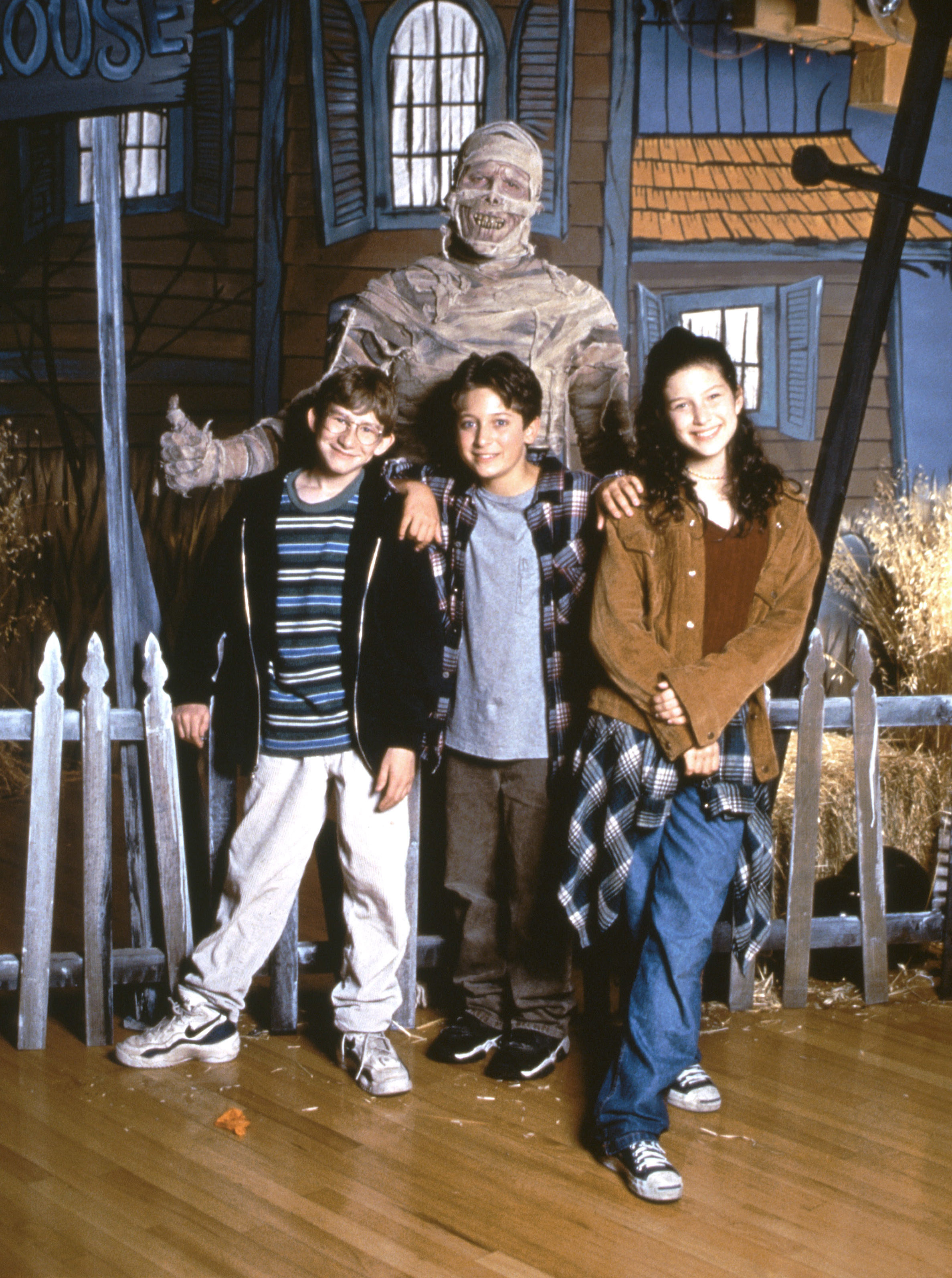 the cast posing with the mummy