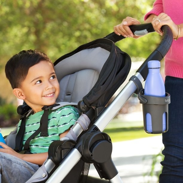 the cupholder holds a water bottle on a stroller