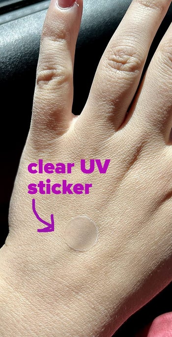 A reviewer wearing a clear UV sticker, labeled 