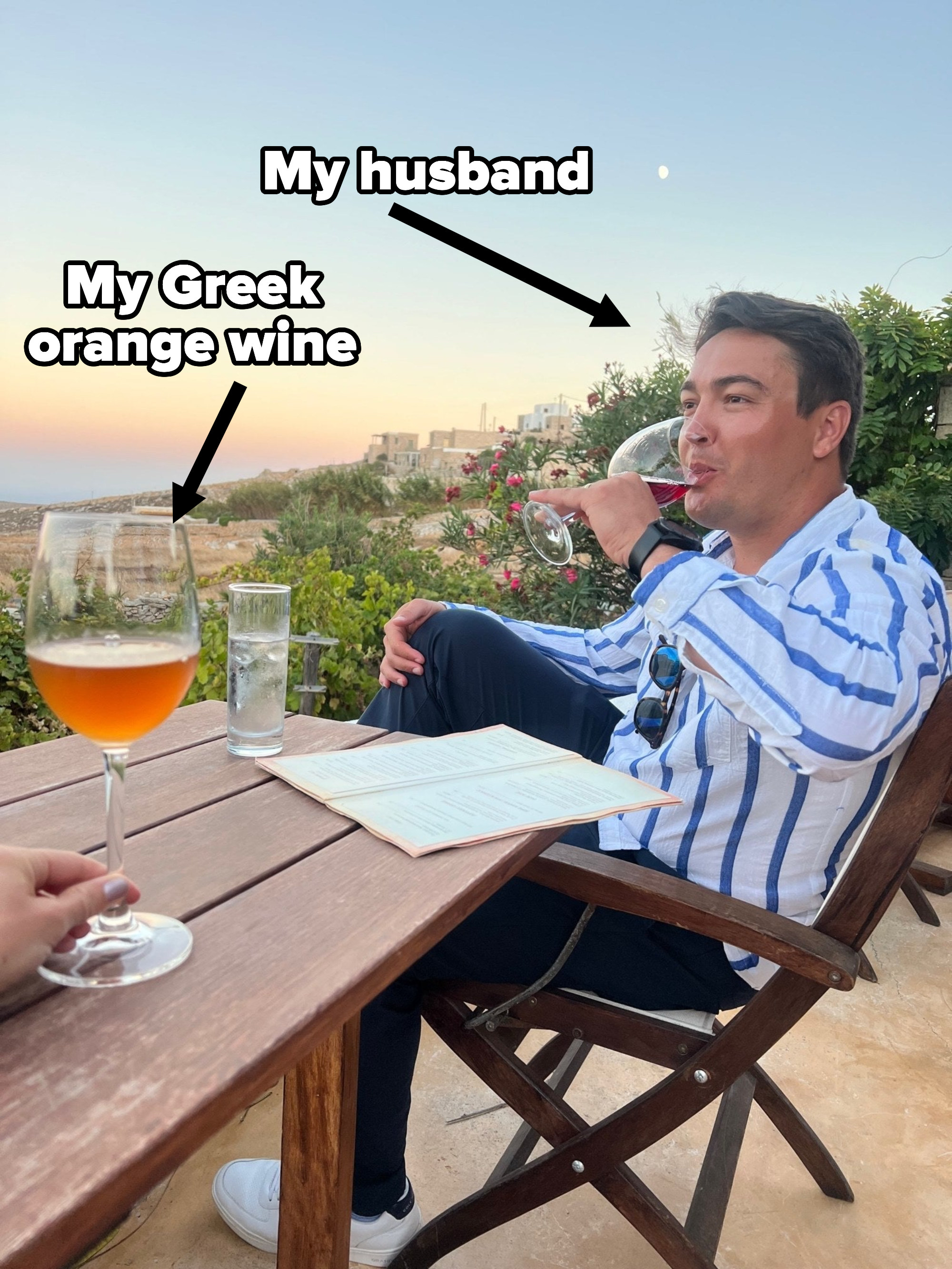 A man drinking a glass of wine.