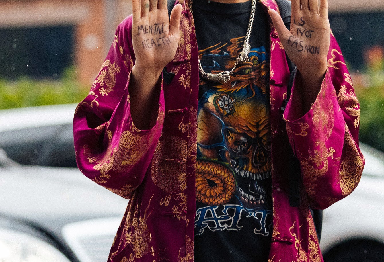 Close-up of the message &quot;Mental health is not fashion&quot; on their palms