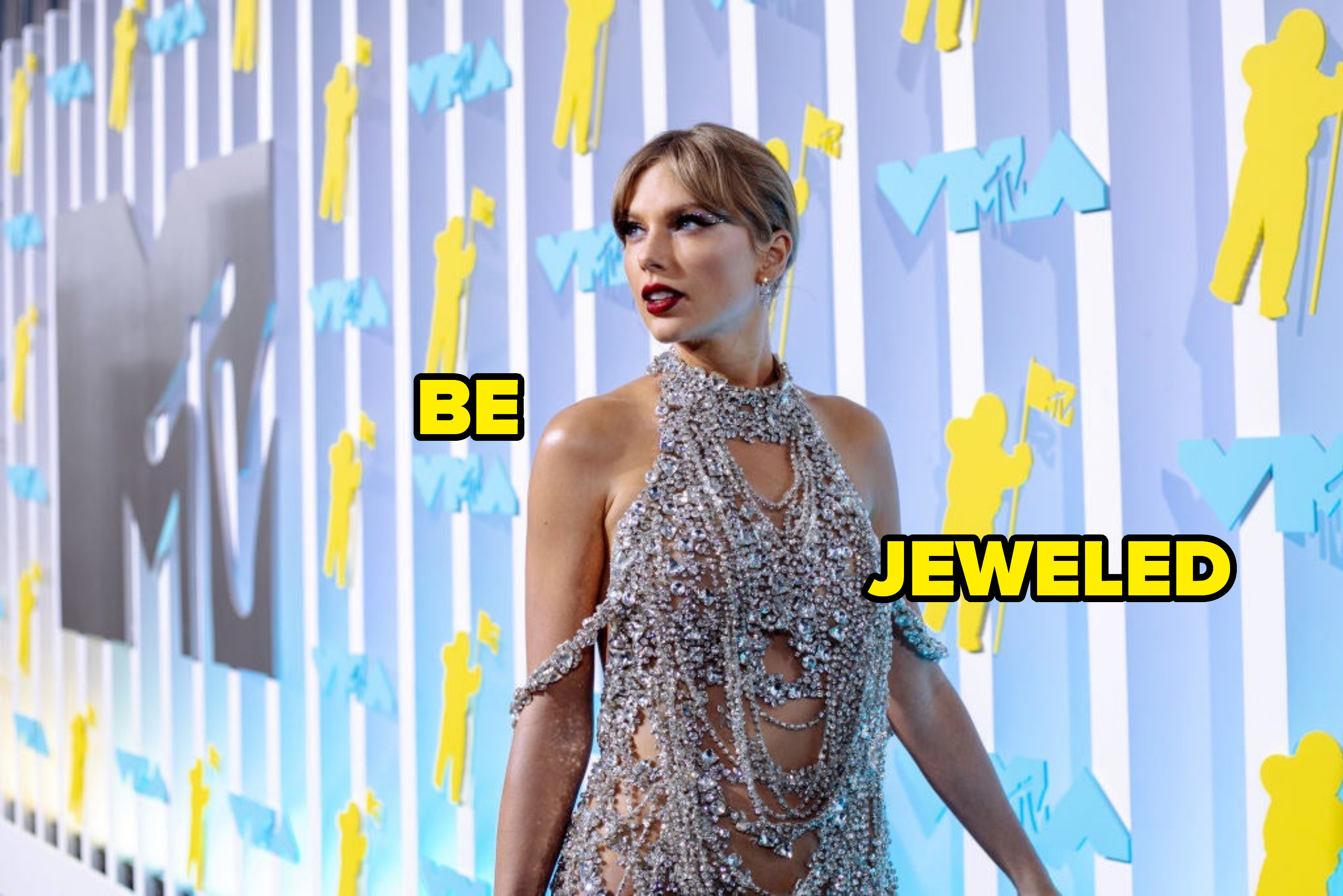 Taylor wearing a bejeweled halter dress on the red carpet