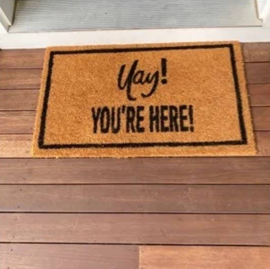 Reviewer&#x27;s photo of the welcome mat, which reads Yay You&#x27;re Here