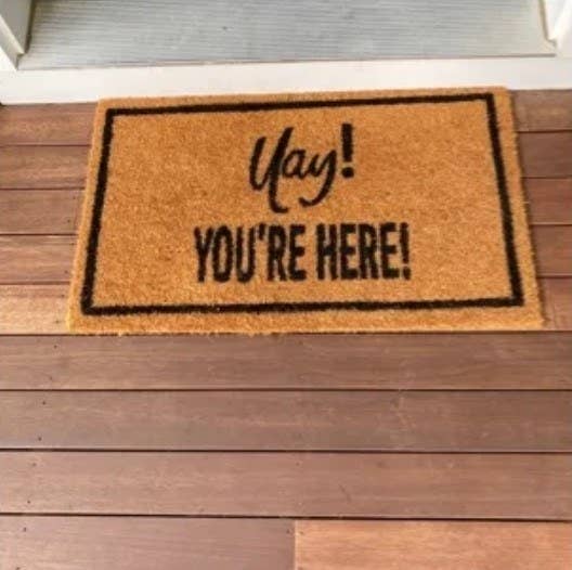 Reviewer's photo of the welcome mat, which reads Yay You're Here