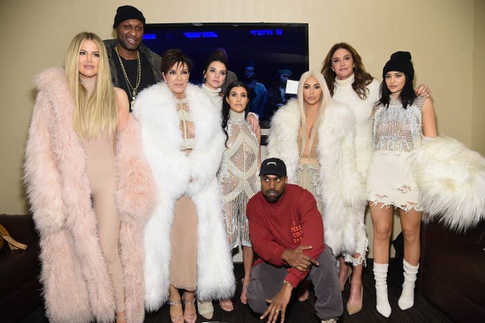 Khloe and her sisters pose for a photo along with Caitlyn Jenner, Kanye, and Lamar Odom