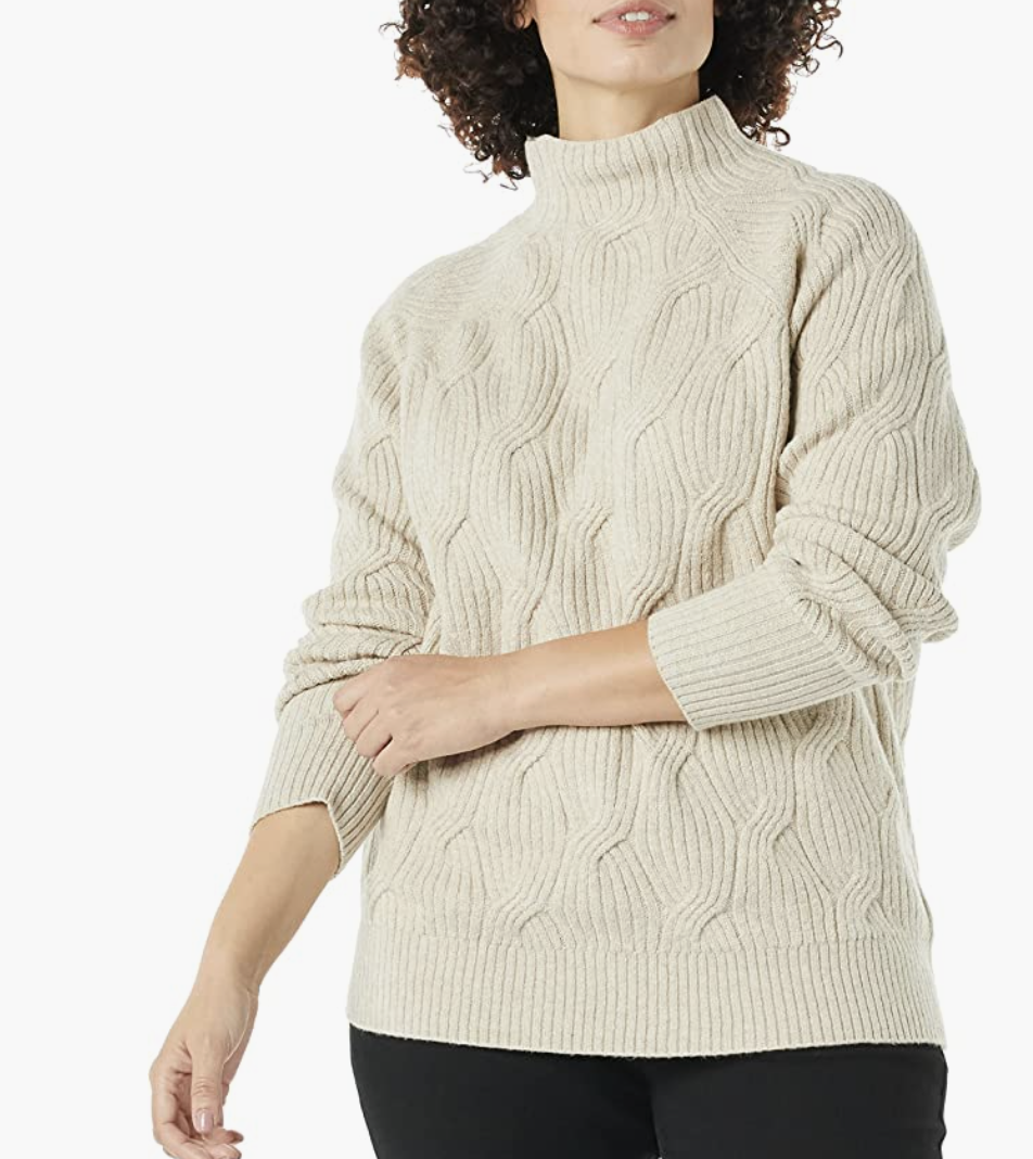 model wearing cable knit sweater in beige